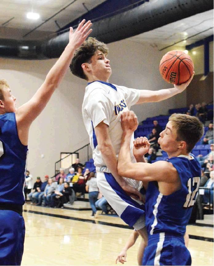 CDN | Collin Wieder                      Arapaho-Butler sophomore guard Ethan Pyron, middle, drives through contact and up for a bucket against Waukomis. Pyron turned in 3.9 assists per game against two turnovers per game.
