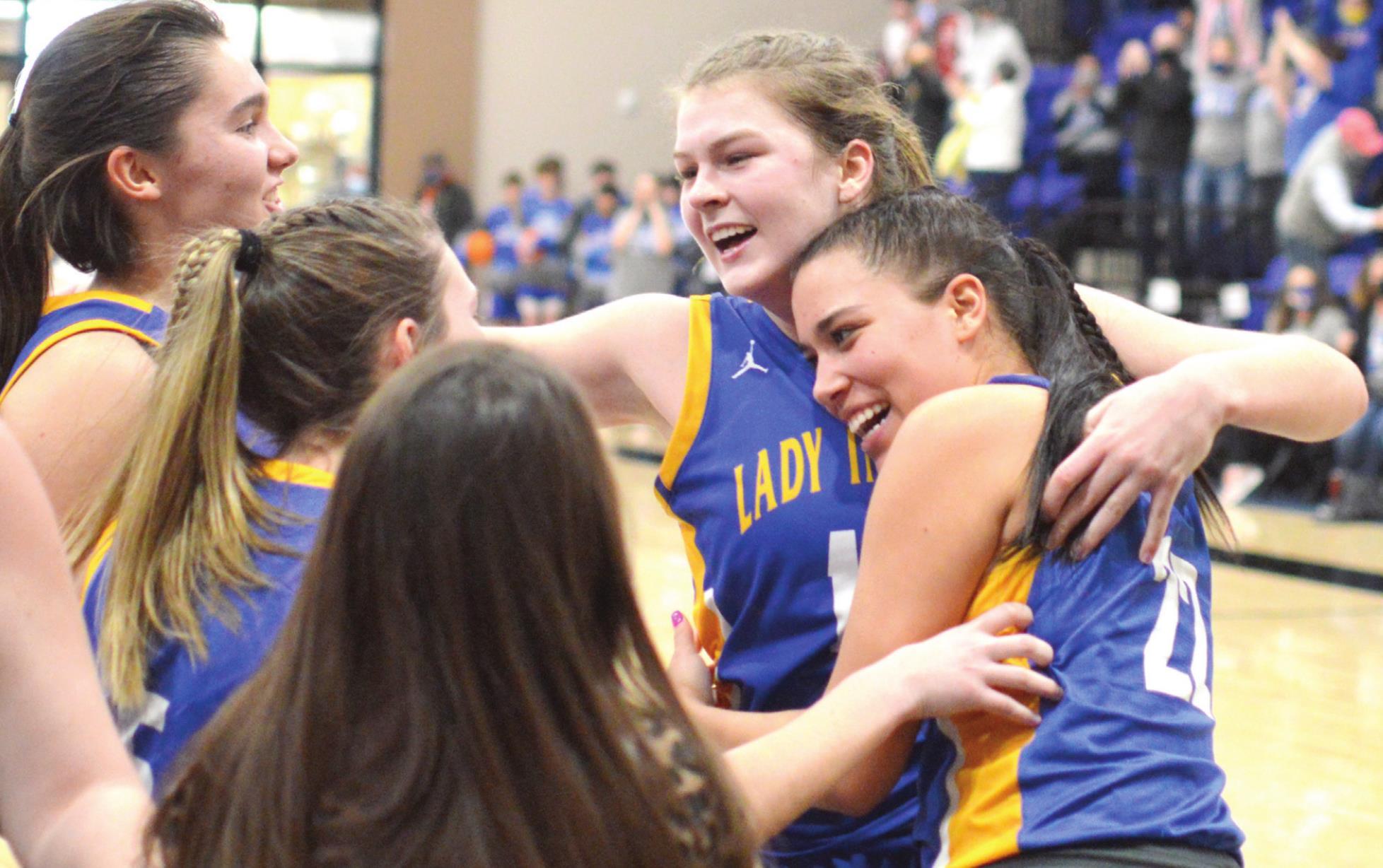 Arapaho-Butler sophomore Katie Edelen is mobbed by teammates, from left, Addison Friesen, Brecken Hunter and Abigail Casas, after hitting the game-winning shot against Waukomis to win the district title. CDN | Collin Wieder