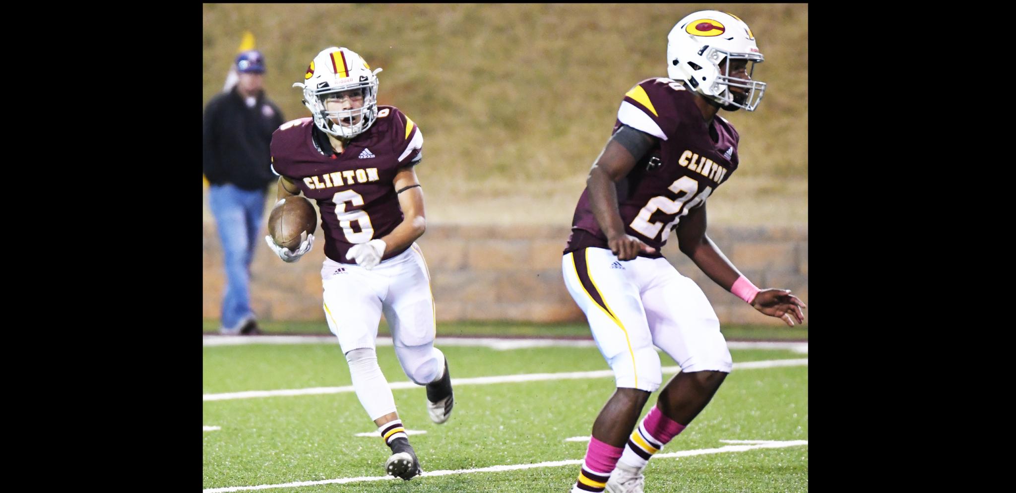 Clinton returner Aaron Seabolt, No. 6, follows a block by Atrel Bryson.