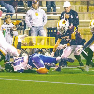 Aaron Seabolt levels Harrah’s Gabe Johnson while Antonio Ceniceros and Garrison Rhoads pursue the loose ball. Rhoads recovered the fumble and Clinton scored on the ensuing possession. Clinton rolls Harrah