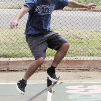 Kaelib Simpson practices his “ollie” skateboard trick Tuesday at McLain Rogers Park in the basketball court. CDN | Christian Jacobsen