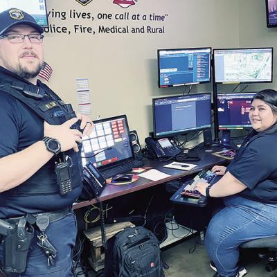 Clinton Police Officer and SRO Andrew Wilson, left, shares information with dispatcher Victoria Luna. CDN | Michael Maresh