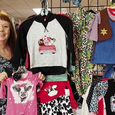 Clairen Reese shows off some of the Freckled Frog’s selection of new and nearly new children’s clothes and accessories. CDN |Nydia Campbell Friendly people draw in new downtown business