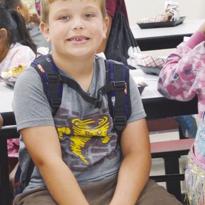 Grayson Wagoner waits for lunch to be over for the outdoor activities at Washington Elementary during Summer Playground. CDN | Christian Jacobsen