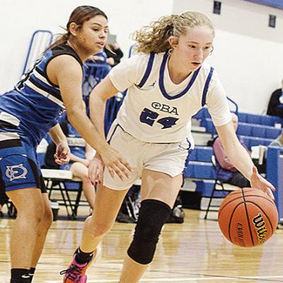 Lady Crusaders’ Brylie Driskill controls the ball against the defender as she drives to the basket in CBA’s win over O-E CDN | Sam Goodwyn