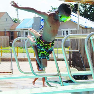 Josiah Ruiz leaps from the diving board at the Clinton Public Pool. CDN |Elisha Rangel Pool back open for summer
