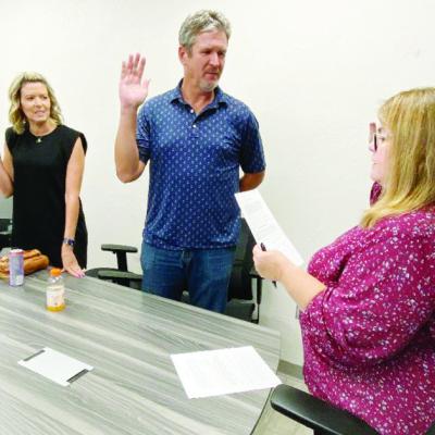 From left, Shea Meget and Luke Adams are sworn in Tuesday at the Frisco Center as trustees for the Clinton Economic Development Authority by City Clerk Amy Jones.