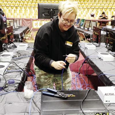 Jessica Cenami helps set up monitors for the Oklahoma Scholastic Esports State Championship held last weekend at Clinton High School. CDN | Courtesy of Steve Wheeler School hosts first Esports tournament