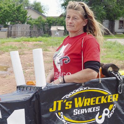 Jennifer Martin stands in a toy train for JT’sWrecking Service at Friday’s Cinco de Mayo parade on Frisco Avenue.