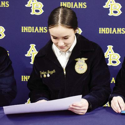 Rylin Oakes, left, and Taeler Baggett, center, look over the flyer for the first annual Arapaho-Butler FFA Best Rib Contest and meal, set to be held tomorrow, while Reese Richardson counts tickets for the event. CDN | Emily Stephens A-B FFA to host fundraiser tomorrow