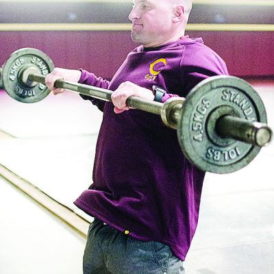 Clinton’s wrestling coach Rhett Blundell works out in the wrestling room over winter break. CDN | Sam Goodwyn