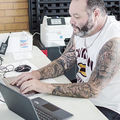 Chris Maley works on the computer to update the brackets during the first day of the recent Hub City Wrestling Tournament at the Tornado Dome. CDN | Sam Goodwyn