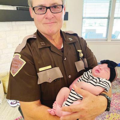 Recently retired Brady Neidy will have a lot more time to do this now, as he holds his granddaughter, Cameron Page Sliauter. CDN | Courtesy photo Neidy retires after 44 years of ensuring public’s safety