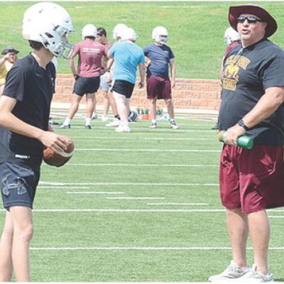 Snider Dowdell, left, gets coached up by Head Coach John Higbee during practice. CDN | Sam Goodwyn