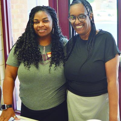Asst. Resource Coordinator Kimberly Hurd, left, and Tosha Jones with Eastside Acadamy share a table during in-person enrollment at Clinton Middle School. CDN | Micah Ashcraft