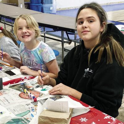 Western Oklahoma Christian School 4H members Ziana Almquist, left, and Seven Jones paint small canvases during the group’s annual Christmas party. Their works were to be displayed at the Clinton Public Library. CDN | Courtesy photo Crafting together