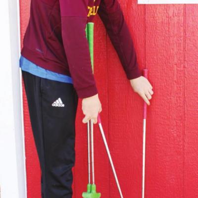 Parker Adams prepares the mini golf course by setting up clubs for visitors to use. Mini-golf in full swing during break