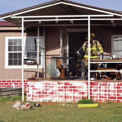 Clinton firemen inspect the inside of a trailer home to make sure the fire is out Monday morning at 10363 N. 2202 Rd., west of Clinton. CDN | Staff Photo