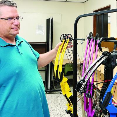 Greg Granger looks at the different bows he has in his classroom. CDN | Courtesy photo CMS kicks off new wildlife skills program to benefit students