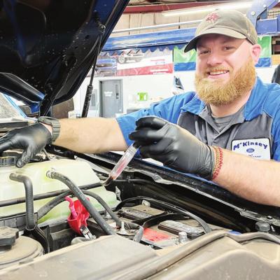 Brayden Lockhart checks one of the vehicles in the service department at McKinsey Ford before upcoming winter weather. CDN | Emily Stephens Preparing vehicles