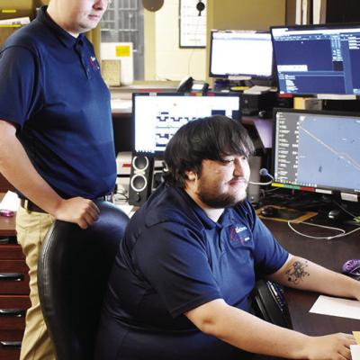 Dispatchers, Chandler Miller, left, and Kade Holman offer support to officers in the field at the Clinton Police Department. CDN | Caleb Blanchard Information hub