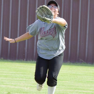 Kari Begay sprints after the softball and catches it during softball pratice Tuesday. CDN | Josh Jennings Lady Reds preparing for softball season