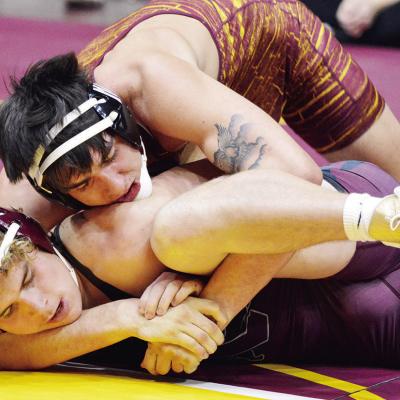 Clinton’s Trey Bennett, top, locks up a cradle to turn his foe Friday in the Hub City Classic. Bennett won the title at 175 pounds and recorded his 100th career victory. CDN | Andrew Cunningham CHS crowns two champs at Hub City