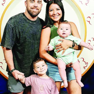Newly hired Clinton boys’ wrestling coach Matt Kennedy, left, holds his son Koe’s hand, and his wife Denise, right, holds their infant Cub while at Disney. CDN | Courtesy photo