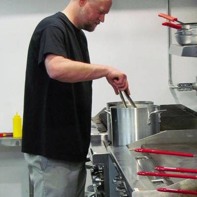 Clint Lively preps food for the coming patrons on the opening night at The B.A.C.K. Room restaurant.