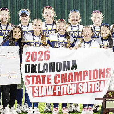 The Arapaho-Butler Lady Indians celebrate winning the 2026 Class 3A Slow-Pitch State Championship Wednesday at FireLake Ball Fields. Pictured from left, in front, are Adrian Randle, Kylin Oakes, Izzie Dewees, Reagan Schoeppach, Maddi Lockhart and Piperril