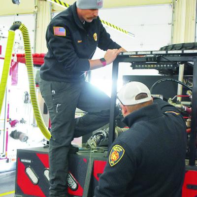 Cpt. D.J. Woodall, left, and Lt. Joe Williams perform maintenance on the back of the Clinton Fire Department’s Brush Pumper 101. CDN | Caleb Blanchard CFD ready to embrace wintry trouble