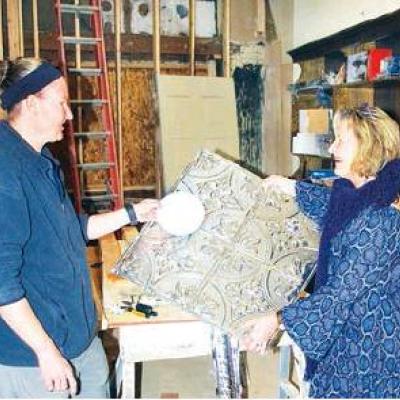 CDN | Robert S. Bryan Electrician Jamie Burden, left, talks with store owner Donnelle Rathael Wollmann about lighting that will be in the ceiling. Store will be ‘destination spot’