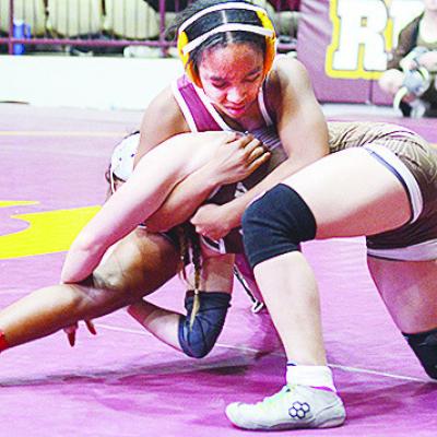 Clinton’s Peyton Clonce wraps her opponent up to avoid a single-leg takedown during the Hub City Wrestling Tournament held at the Tornado Dome. CDN | Sam Goodwyn