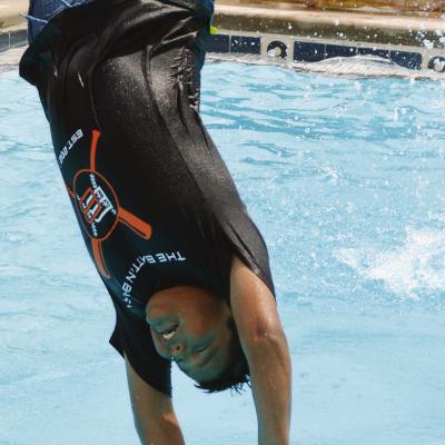 Cruz Standingwater gets too much bounce and his legs fly away at the Clinton Public Pool. CDN | Christian Jacobsen