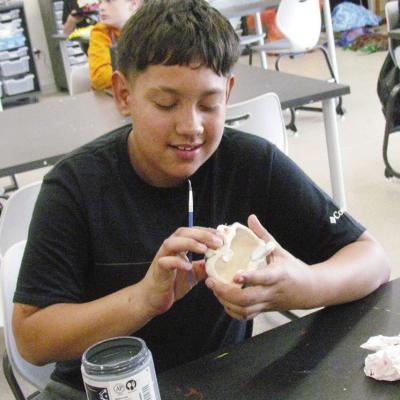 Ethan Quezada is in class making a big mouth art sculpture at Clinton Middle School. CDN | Christian Jacobsen