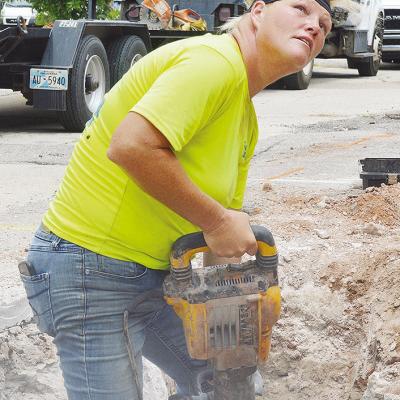 Crystal Rushing drills underground to install new fiber optic lines on Ninth Street between Gary Boulevard and Frisco Avenue Thursday afternoon. CDN | Micah Ashcraft