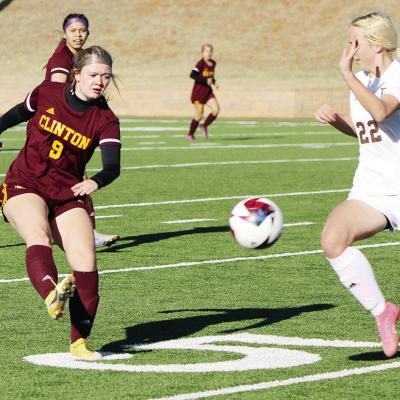 Clinton’s No. 9 Mia Miskel boots the ball past the Elk City player during the Lady Reds’ 2-0 win over the Elkettes. CDN | Emily Stephens Clinton soccer teams blank Elk City