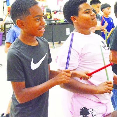 Amari Reed, left, and JaMarley Littleton feel the groove while they take part in a singing and dancing activity during music class at Southwest Elementary. CDN | Micah Ashcraft