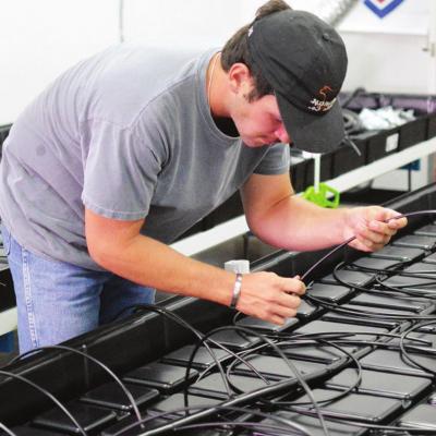 Performance Grow intern Steven Sawatzky pieces together parts of a grow system in the warehouse, located inside SportChassis. CDN | Collin Wieder SportChassis ‘grows’ into new business operation