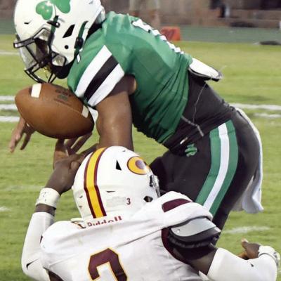 Zaedon Collins strips the football, forcing a fumble in which the Reds recovered. CDN | John Kinsey Reds lose to McGuinness