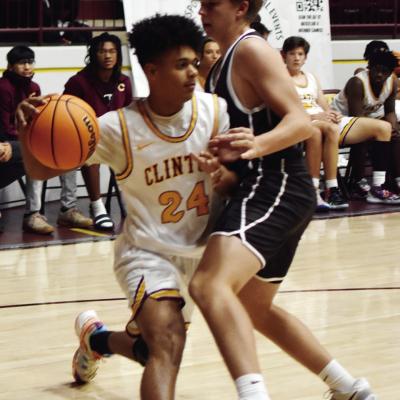 Clinton’s Kyler Ringo-Kabunda dribbles around an Elk City defender. Tomorrow CHS travels to Tuttle. CDN | Emily Stephens Brushing by