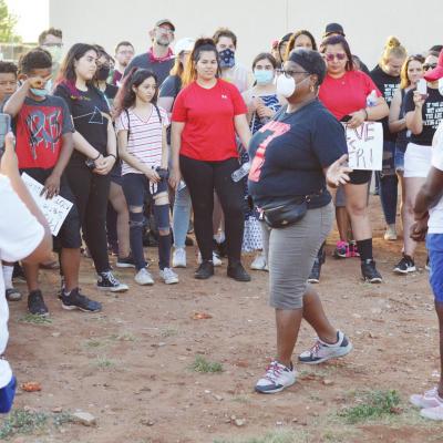Susanna Williams, center, school board member, addresses the crowd of people who assembled for Saturday’s demonstration. Jennifer Barron, at left with back turned, and L.J. Williams are also visible. Large crowd gathers for protest