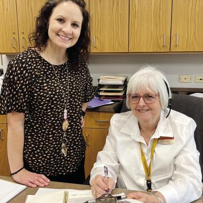Washington Elementary Counselor Ashley Miller, left, and Secretary Ann Moore look over the attendance Moore still vital part of Washington Elementary