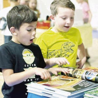 Evander Spradlin, left, and Kiptyn Palmer marvel at shark facts while perusing a book at the WOCS book fair. The boys’ eyes went wide as they discovered something amazing about the ocean predators. CDN | Courtesy photo Gasping at shark secrets
