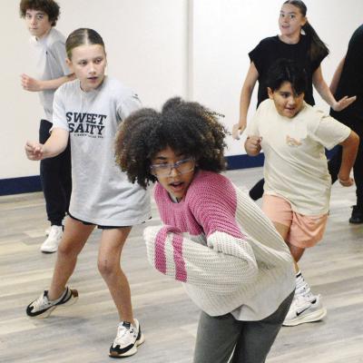Spark Project students practice out the dance moves for the song “A Little More Homework” from the play “13: The Musical” at The Spark Project on Frisco. Students from left are Alex Stratton, Tinlee Chase, Huyler Christensen, Christian Hensley, an