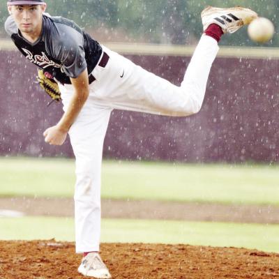 Craig Hunter watches his pitch through the rain during Clinton’s Thursday home summer game against Chickasha. CDN | Sam Goodwyn Reds fall in summer baseball home opener