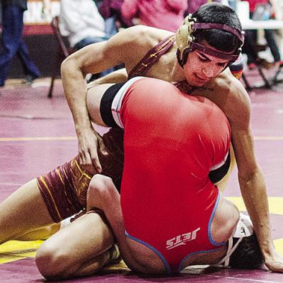 Clinton’s Vicente Gutierrez, top, tries to roll his opponent over during the annual Hub City Tournament Friday in the Tornado Dome. CDN | Sam Goodwyn