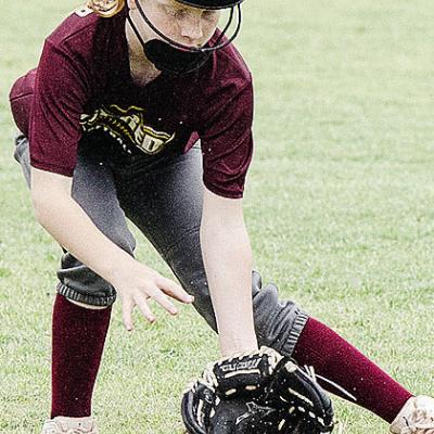 Stella McCarther focuses on the ball as she fields it in the OK Kids 8U Softball State Tournament at Schumacher Fields at Acme Brick Park. CDN |Sam Goodwyn