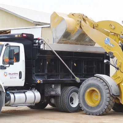 Oklahoma Transportation workers fill up a truck with a salt, sand and screening mixture to keep ice off the roads, in preparation for inclement weather. Patrick Jones, left, of Clinton, prepares to drive the truck, while Brandon Lathrom, of Clinton, dumps Crews stay ready for icy roads