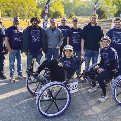 SWOSU Rover Dawgs pose with their human-powered rover at NASA’s Human Exploration Rover Challenge. From left are Brett Chase, Nathan Brooks, Tomas Izquierdo, Mason Pritchard, Brandon Ogle, Caden Tucker, Justin Wiersema, and Kamryn Brewer; seated, Ana Ar